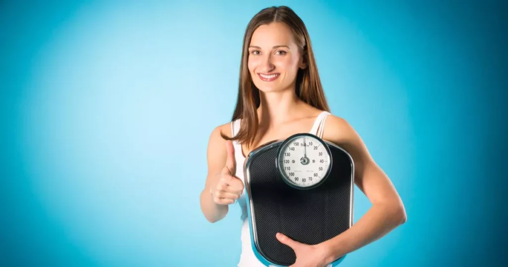 Diet and loosing weight, young woman with a scale