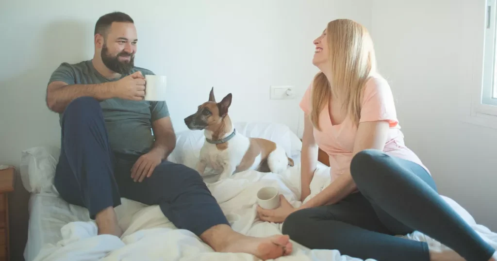 Dog Enjoying with Man and Women